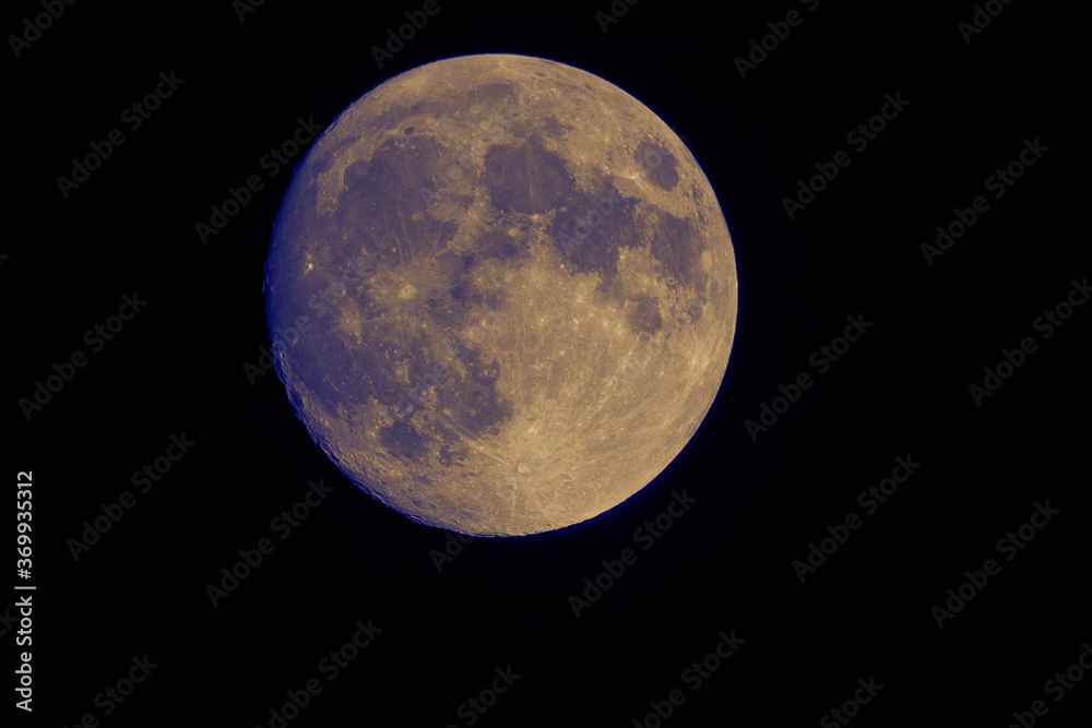 Naklejka premium Telescope view of the full moon in the night sky