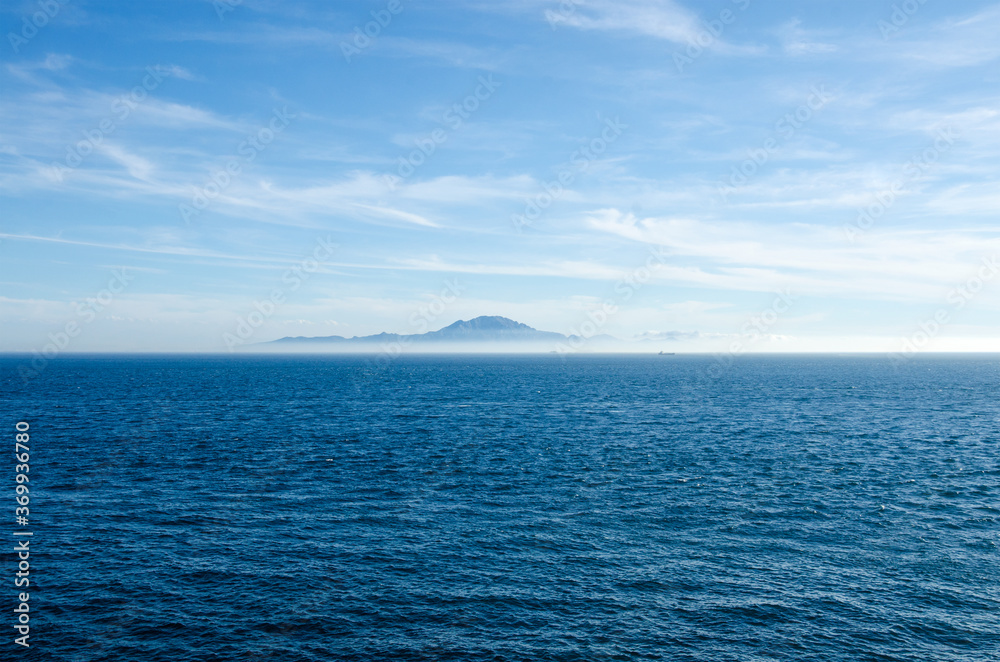View of Strait of Gibraltar from British overseas territory Gibraltar. Morocco and mount Jebel Musa on the background. View of Strait of Gibraltar from British overseas territory Gibraltar. Morocco and mount Jebel Musa on the background.