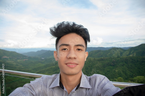 Asian man take photo selfie with view mountain