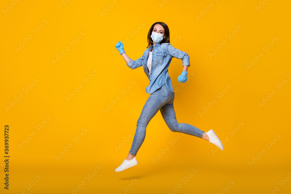 Full length body size profile side view of her she nice attractive active healthy slim girl wearing safety mask jumping running stop flu isolated bright vivid shine vibrant yellow color background