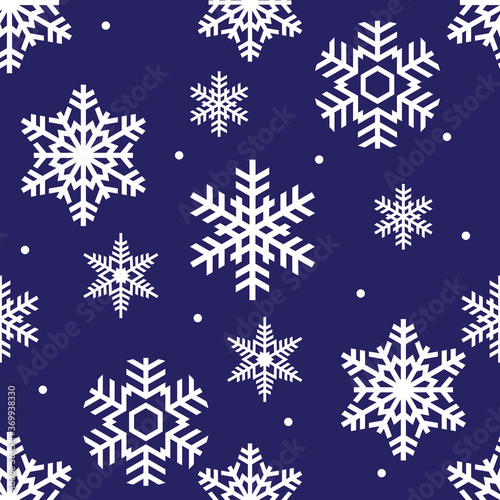 seamless winter pattern of white openwork snowflakes on a blue background