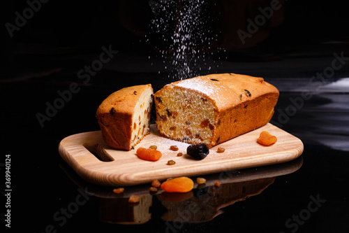 Sweet cupcake in the shape of bread. Cupcake with raisins, dried apricots, plums.