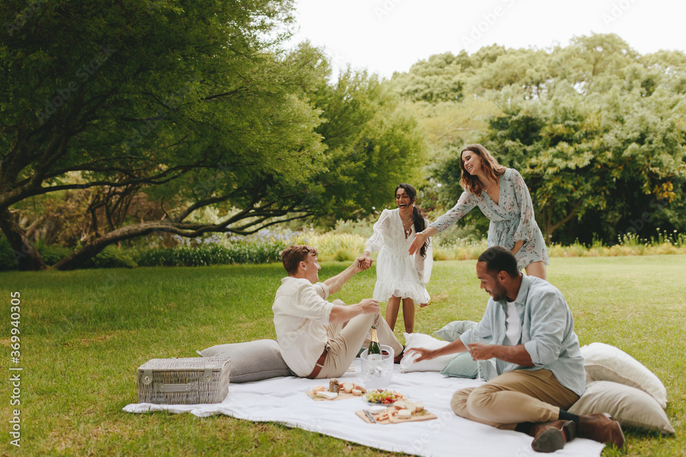 Group of friends on a picnic at park Group of friends on a picnic at park