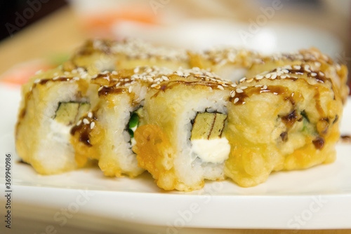 Hot sushi with tomago omelette and unagi sauce, close-up.