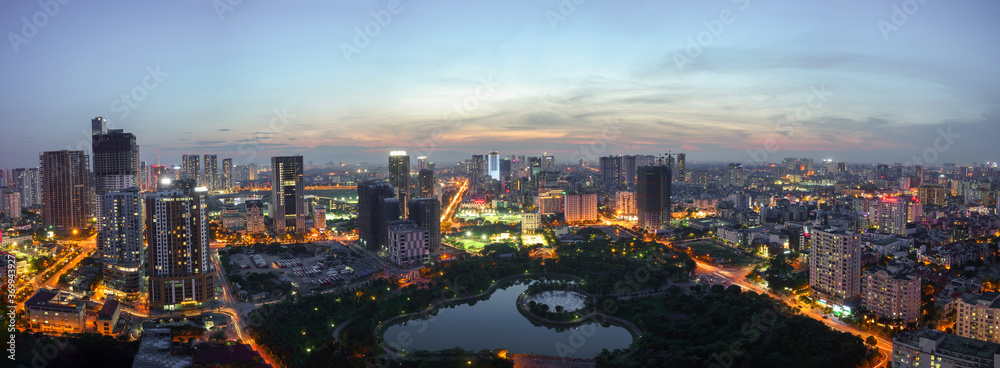 Fototapeta premium Cityscape of Hanoi skyline at Cau Giay park during sunset time in Hanoi city, Vietnam