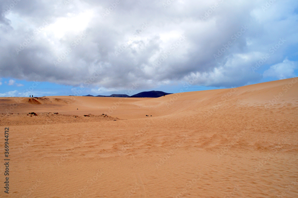 huge sand dunes with clouds hanging over them and mountains on the horizon. Corralejo dunas, Fuerteventura, Canary islands
huge sand dunes with clouds hanging over them and mountains on the horizon. Corralejo dunas, Fuerteventura, Canary islands