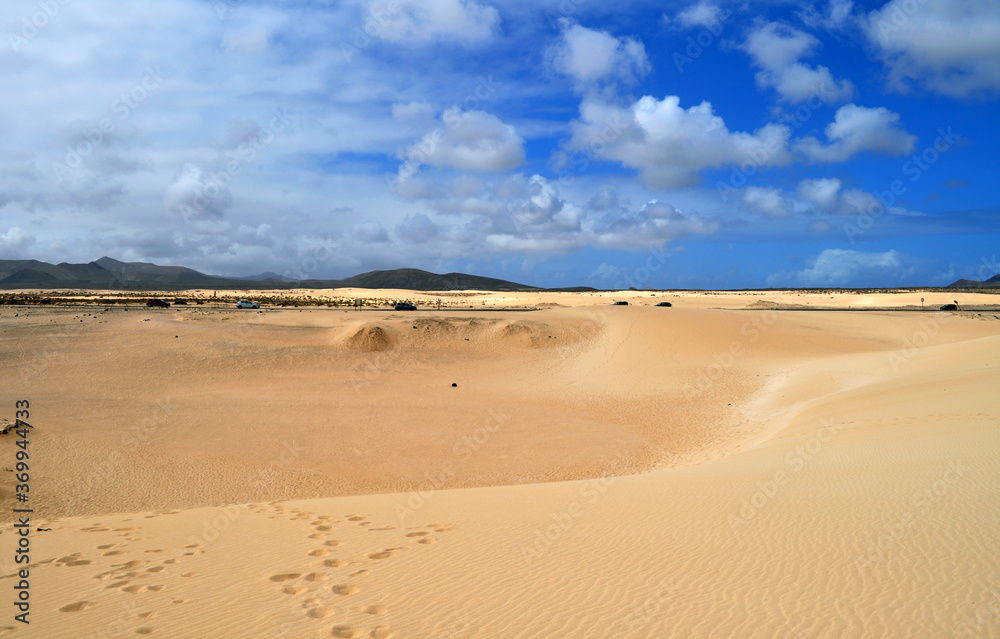 
Road through the desert, huge sand dunes and beautiful clouds. Dunas de Corralejo, Fuerteventura, Canary Islands