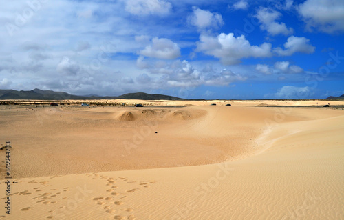  Road through the desert  huge sand dunes and beautiful clouds. Dunas de Corralejo  Fuerteventura  Canary Islands