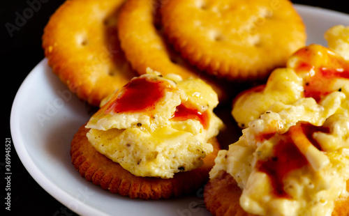 Salty biscutis with topping of cheese ,fluffy eggs and ketchup.