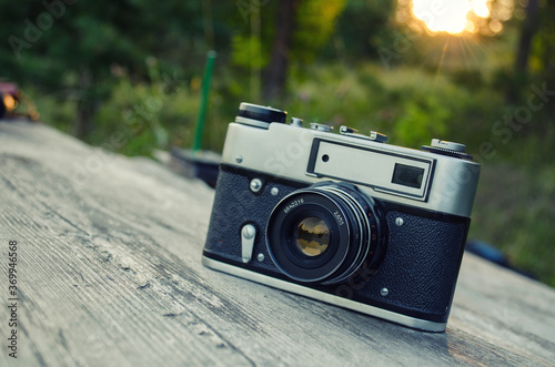 old camera in nature , green and yellow background