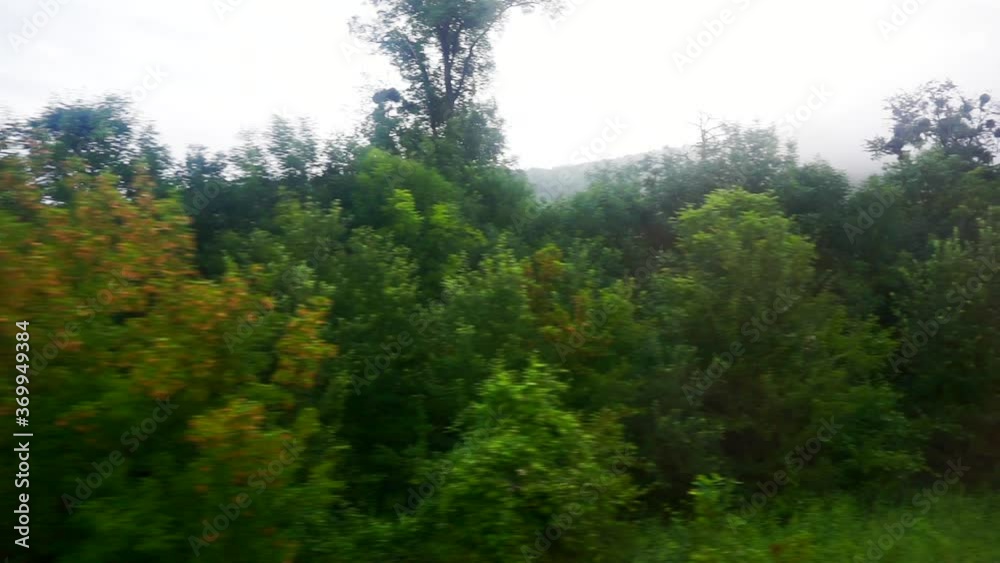 Scenery from the window of a moving train with green landscape Scenery from the window of a moving train with green landscape