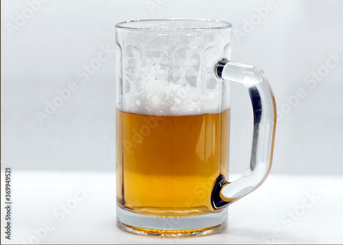 Glass mug of beer with foam