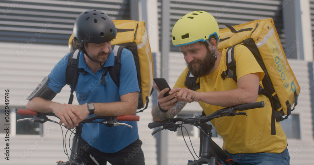 Bicycle messengers check smartphone Stock Photo Adobe Stock