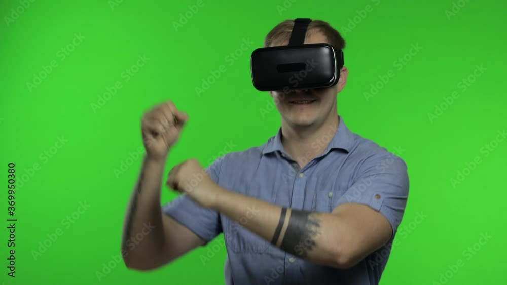 Man using VR headset helmet to play game. Watching virtual reality 3d 360 video. Chroma key Man using VR headset helmet to play game. Watching virtual reality 3d 360 video. Chroma key