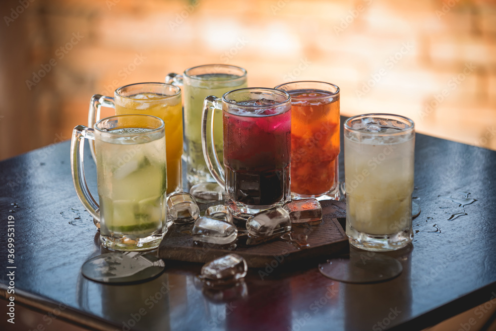 lemon, strawberry, kiwi, passion fruit caipirinhas, with ice spread over rustic table lemon, strawberry, kiwi, passion fruit caipirinhas, with ice spread over rustic table