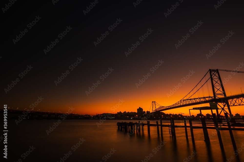 Colorful sunset behind the Hercílio Luz bridge in Florianópolis, copy space