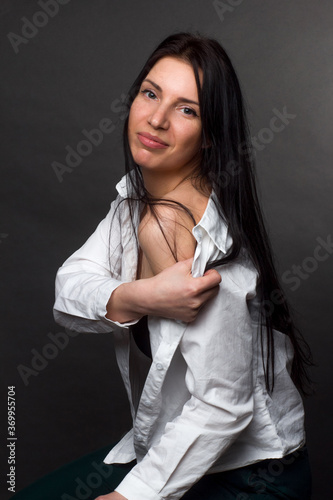 portrait of a brunette in a white knotted shirt