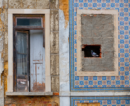 Derelict facade of an abandoned building in Lisbon decorated with traditional portuguese tiles called "azulejos" © ncortinhal