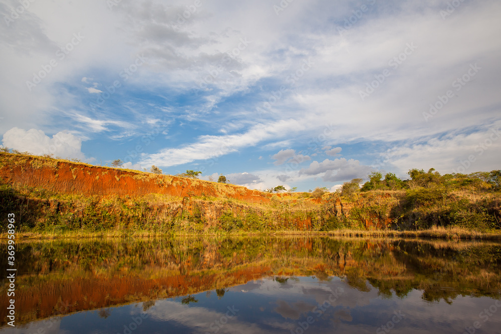 Reflexive lake with blue sky, clouds and green vegetation Reflexive lake with blue sky, clouds and green vegetation