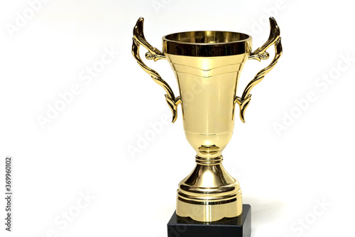 Cheap universal loving cup trophy made of plastic with golden coating isolated
