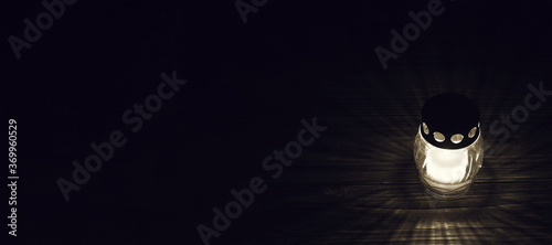 Photography White grave candle on dark background with copy space.