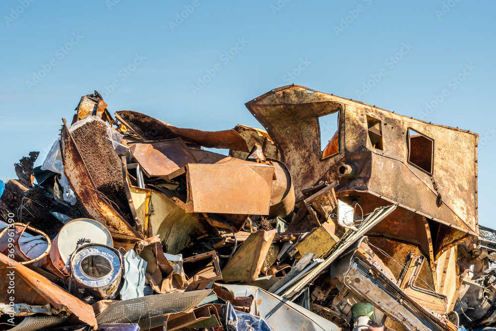 Pile of scrap black metal under blue sky Pile of scrap black metal under blue sky
