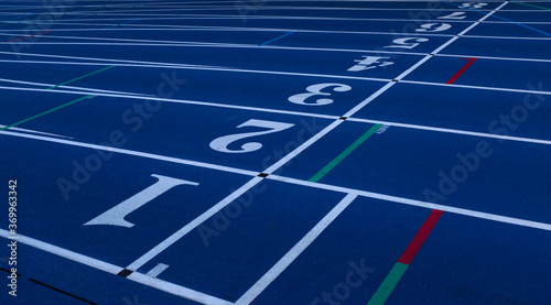Blue Running Track with White Lane Numbers and Red and Green Lines