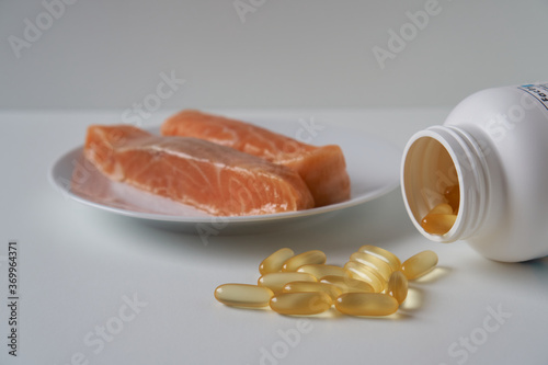 Fish oil capsules and salmon fillet slice 
