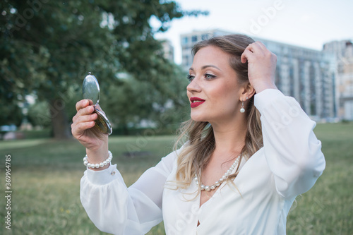 Summer outdoor porttrait of young pretty elegant girl photo