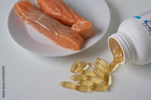 Fish oil capsules and salmon fillet slice   
