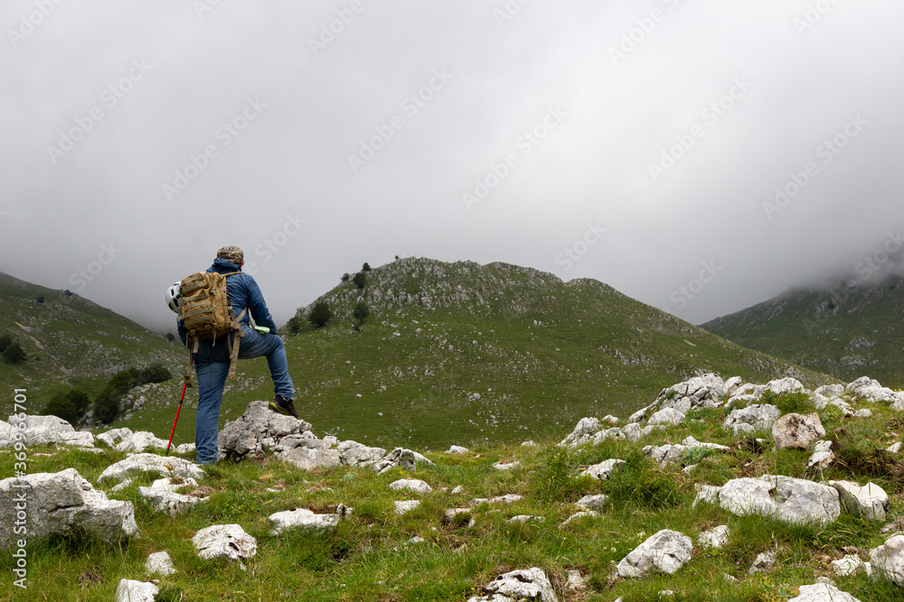 hiker on the top of a mountain on Gallinola in Matese Park hiker on the top of a mountain on Gallinola in Matese Park