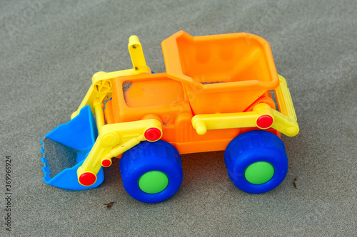 A plastic toy sand truck at the beach