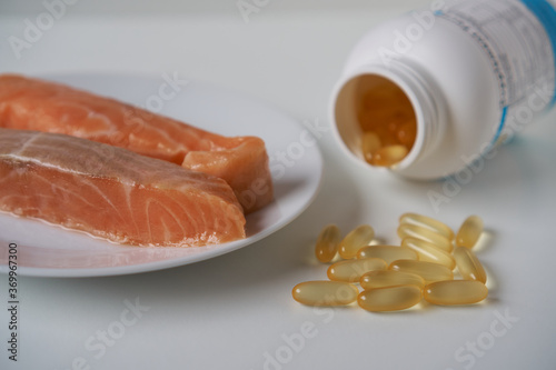 Fish oil capsules and salmon fillet slice   