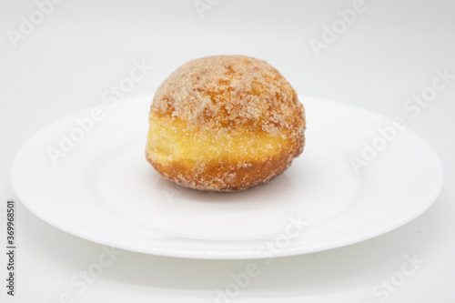Simple Sugared Stuffed Custard Donut on a White Plate with a White Background