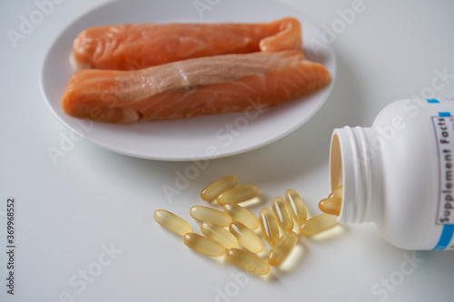 Fish oil capsules and salmon fillet slice   