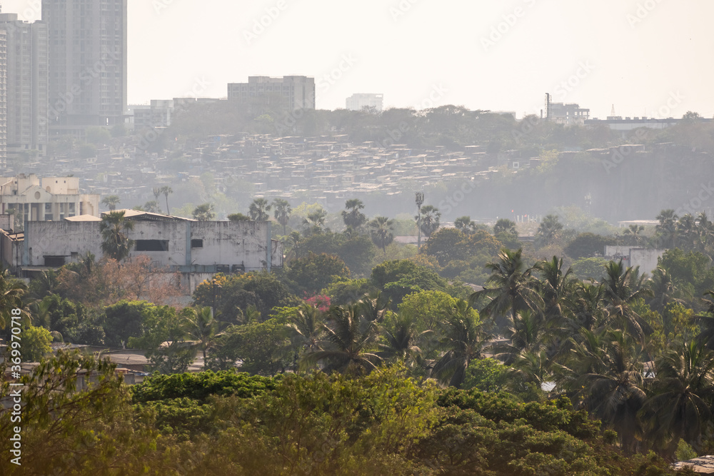 Trees, slums and buildings in hazy Mumbai