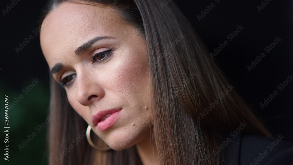 Thoughtful woman face. Closeup serious businesswoman looking down