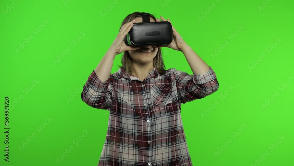 Woman using VR headset helmet to play game, dance. Watching virtual reality 3d video. Chroma key Woman using VR headset helmet to play game, dance. Watching virtual reality 3d video. Chroma key