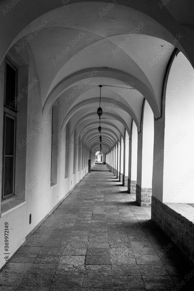 Empty vintage galleryю corridor with arches.