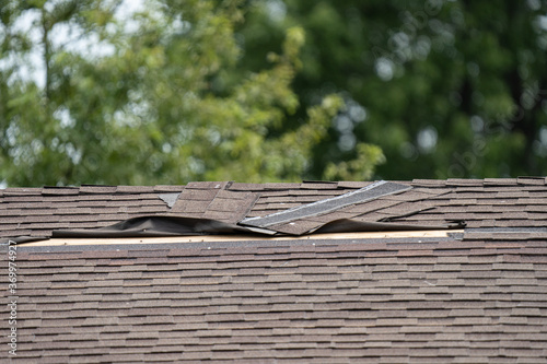 roof shingles have been damaged by high winds and strong storms
