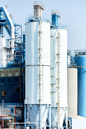 Two factory constructions with vertical ladders. photo