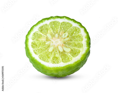 half of bergamot or kaffir with seeds on white background