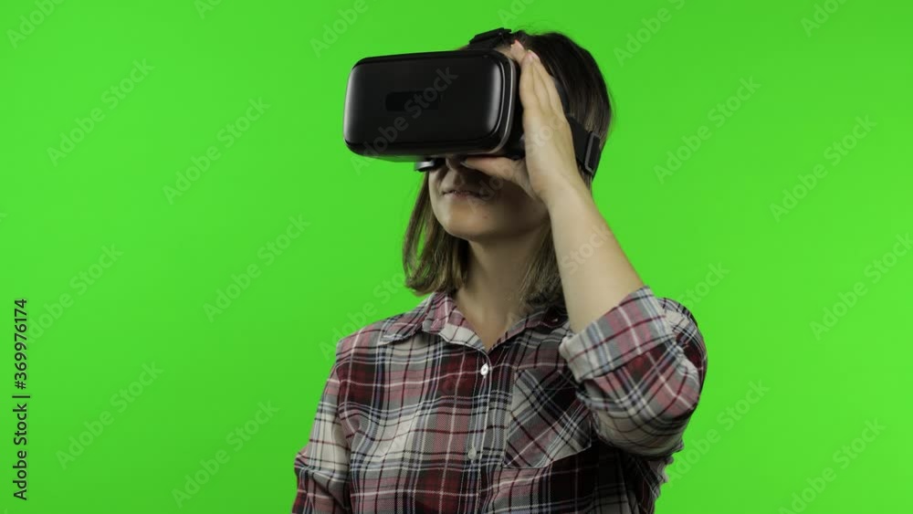 Girl using VR app helmet to play simulation game. Slide gestures. Watching virtual reality 3d video Girl using VR app helmet to play simulation game. Slide gestures. Watching virtual reality 3d video