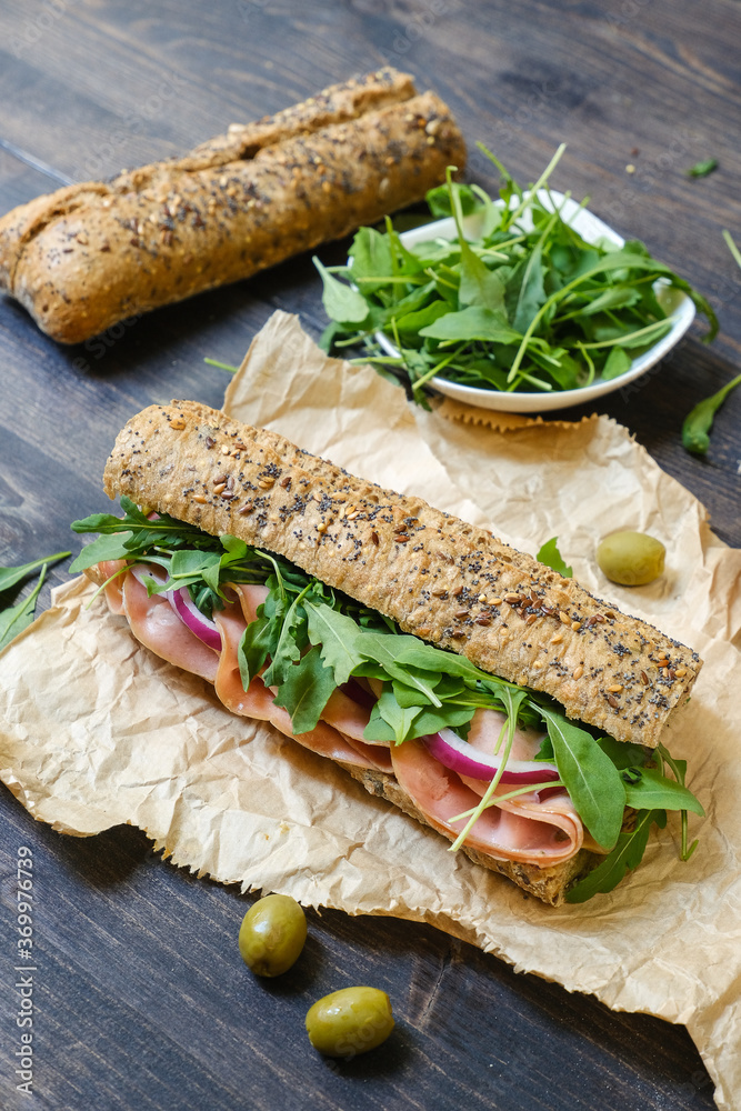 Sandwich with Italian mortadella, arugula and multigrain baguette