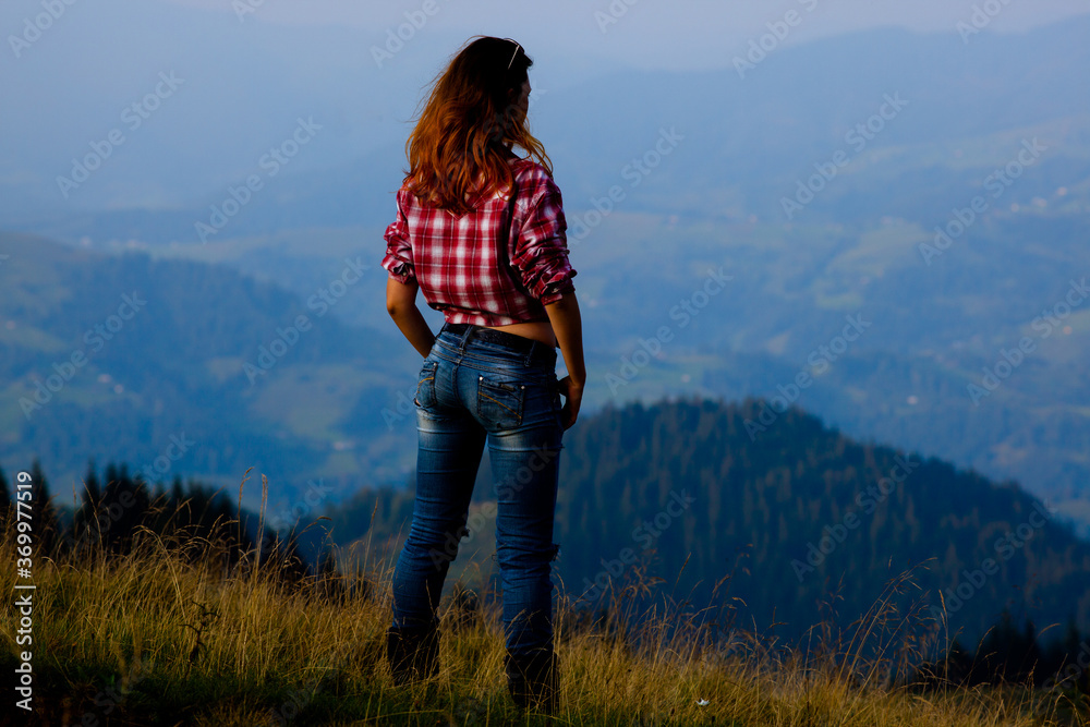 girl in a stylish men's shirt and blue jeans