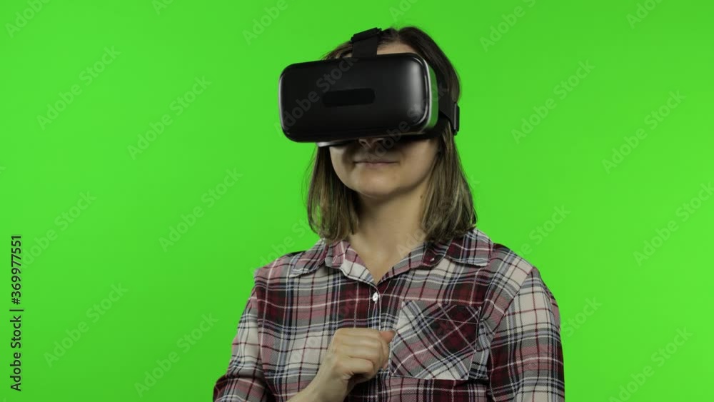 Girl using VR app helmet to play simulation game. Slide gestures. Watching virtual reality 3d video Girl using VR app helmet to play simulation game. Slide gestures. Watching virtual reality 3d video