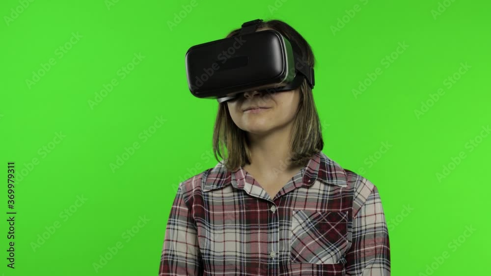 Woman using VR headset helmet to play game, dance. Watching virtual reality 3d video. Chroma key Woman using VR headset helmet to play game, dance. Watching virtual reality 3d video. Chroma key