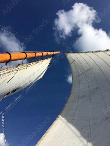 Looking up at sails of a traditional vessel photo