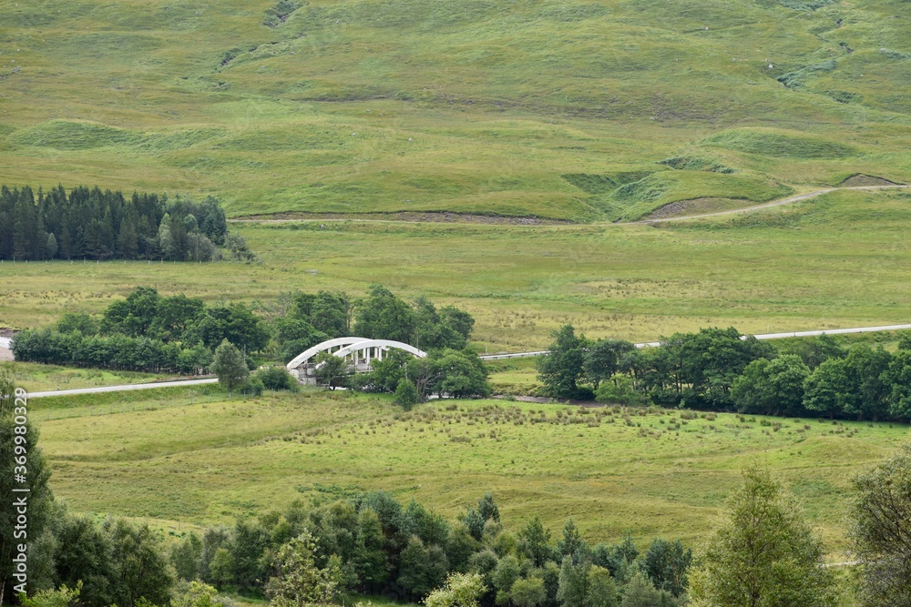 White bridge over a small river in Scotland countryside 