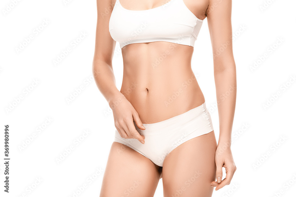 cropped view of young woman with perfect body in panties and top standing isolated on white